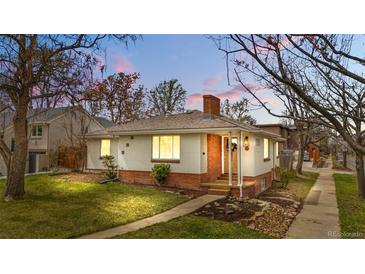 Charming single-Gathering home with brick accents, well-maintained lawn, and inviting curb appeal at dusk at 1295 Elm St, Denver, CO 80220