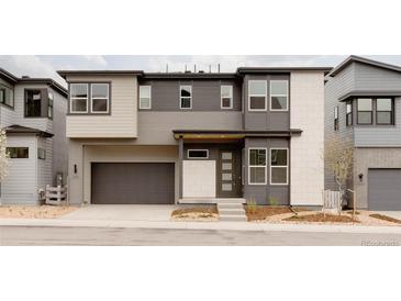 Modern two-story home boasting a multi-tone color scheme, attached garage, and inviting front entry at 11491 Alla Breve Cir, Lone Tree, CO 80134