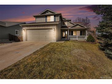 Inviting two-story home with a two-car garage, brick accents, and a cozy front porch at 13451 Clermont St, Thornton, CO 80241