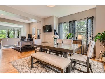 Inviting dining room features a wooden table and an adjacent office space for added versatility at 9424 Ridgeline Blvd, Highlands Ranch, CO 80129