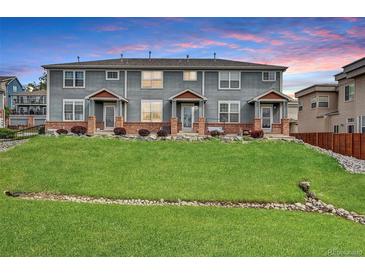 Inviting multi-Gathering exterior with manicured lawn, brick accents, and beautiful landscaping at 8237 W 54Th Ave # 2, Arvada, CO 80002