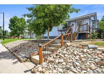 Charming two-story home with a landscaped front yard and inviting entrance at 3306 S Logan St, Englewood, CO 80113