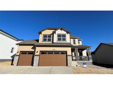 Charming two-story home featuring a 2-car garage and inviting front porch at 16830 Mckay Dr, Mead, CO 80542