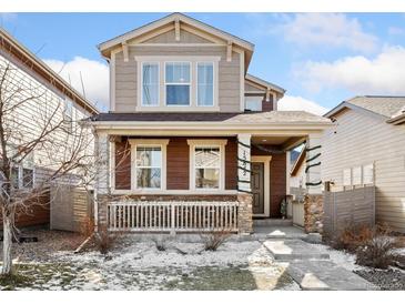 Two-story house with brown and beige siding, front porch, and landscaping at 15842 E Warner Dr, Denver, CO 80239