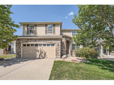 Charming two-story home with brick accents, shutters, and a well-maintained lawn at 16685 Trail Sky Cir, Parker, CO 80134