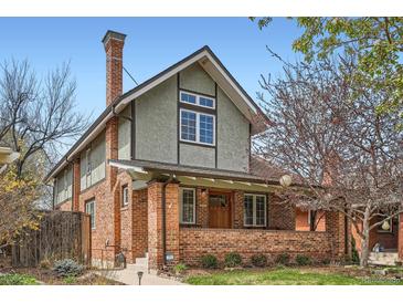Charming two-story brick home with inviting front porch and landscaped front yard at 821 S High St, Denver, CO 80209