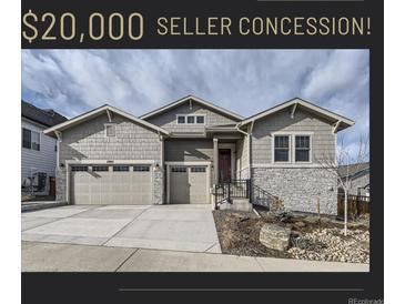 Inviting home featuring a three-car garage, stone accents, and well-maintained landscaping at 2905 Morningbird Ln, Castle Rock, CO 80109