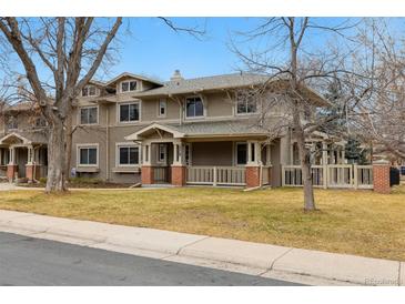 Charming multi-story home featuring a covered porch, well-maintained lawn, and inviting curb appeal at 275 Pontiac St, Denver, CO 80220
