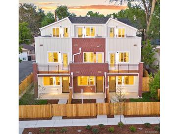 New construction townhome with fenced yards and shared balcony space at 1048 Knox Ct, Denver, CO 80204