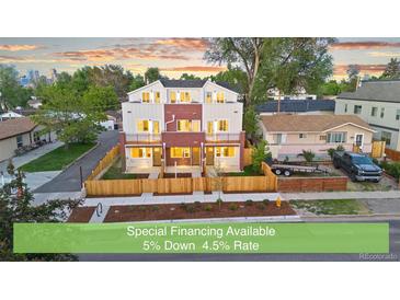 Newly constructed townhomes featuring a charming brick and siding exterior with fenced front yards at 1048 Knox Ct, Denver, CO 80204