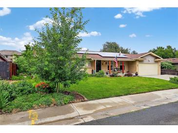 Charming ranch home featuring solar panels, a well-maintained lawn, and lovely landscaping at 11835 W 37Th Pl, Wheat Ridge, CO 80033