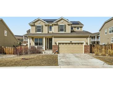 Charming two-story home with well-maintained landscaping, solar panels, and inviting front porch at 13341 Olive St, Thornton, CO 80602