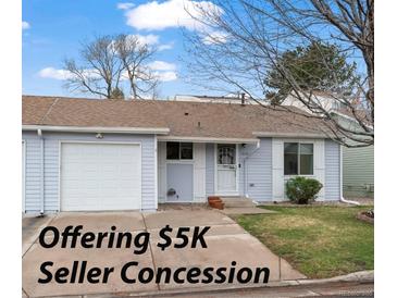 Charming single-story home with light blue siding, attached garage and well-maintained front yard at 16120 E Radcliff Pl, Aurora, CO 80015