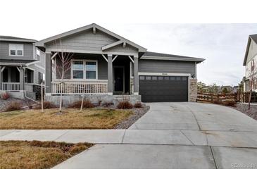 Charming single-Gathering home with a gray exterior, covered porch, and attached two-car garage at 26554 E Indore Ave, Aurora, CO 80016