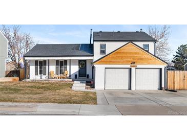 Updated two-story home with a modern facade, two-car garage, and inviting front porch at 12293 W Saratoga Ave, Morrison, CO 80465