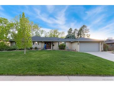 Charming ranch-style home features a well-manicured lawn, brick facade, and attached two-car garage at 3807 S Jasmine St, Denver, CO 80237