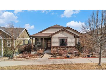 Charming single-story home with stone accents, covered porch, and well-maintained landscaping at 4318 Fossil Way, Castle Rock, CO 80109