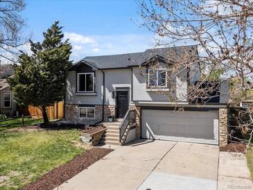 Charming two-story home with a well-manicured front yard and attached two-car garage at 10895 W Bowles Pl, Littleton, CO 80127