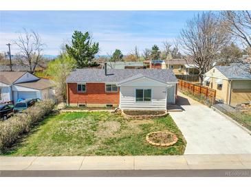 Exterior front view of home with green lawn and driveway on a sunny day at 7819 Tejon St, Denver, CO 80221