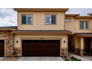 Beautiful two-story home featuring stone accents and a two-car garage at 12254 Hazel Spruce Ct, Parker, CO 80134