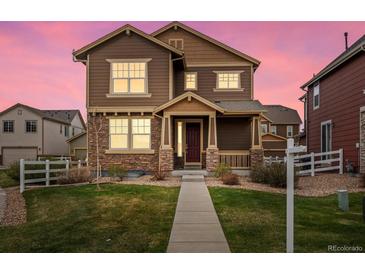 Charming two-story home with a welcoming front porch and beautiful stone accents at 1344 S Coolidge Cir, Aurora, CO 80018