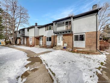 Charming townhomes with brick and siding exteriors and small balconies on the second floor at 3061 W 92Nd Ave # 11B, Westminster, CO 80031