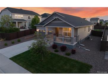 Charming home featuring landscaped front yard, inviting porch and an attached two-car garage at 14431 Forest St, Thornton, CO 80602