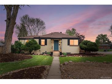 Charming home with a well-manicured lawn, rock landscaping, and inviting front entrance at 3000 N Fillmore St, Denver, CO 80205