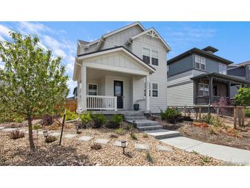 Charming two-story home featuring a cozy front porch and well-maintained landscaping at 2862 E 103Rd Ave, Denver, CO 80229