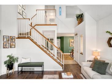 Spacious living room features a cozy fireplace and hardwood floors at 8117 W 90Th Dr, Westminster, CO 80021