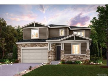 Two-story house with stone accents and a two-car garage at 13840 Deertrack Ln, Parker, CO 80134