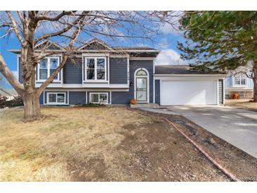 Gray siding house with a 2-car garage and landscaped yard at 5769 S Nepal Ct, Centennial, CO 80015