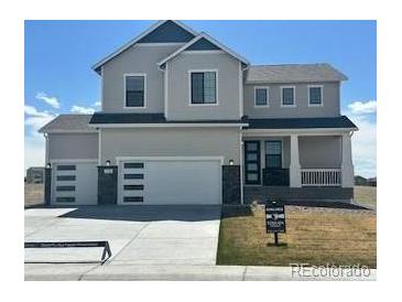 Beautiful two story home features a three car garage, modern design, and manicured lawn at 42984 Colonial Trl, Elizabeth, CO 80107