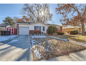 Ranch style home with attached garage and landscaped yard at 9676 Rensselaer Dr, Arvada, CO 80004