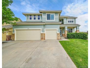 Charming two-story home boasts a well-manicured lawn and a convenient two-car garage at 3590 S Malaya St, Aurora, CO 80013