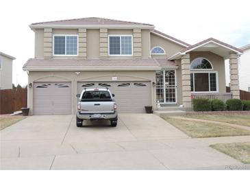 Attractive two-story home with a two car garage and well-maintained lawn at 21024 E 49Th Ave, Denver, CO 80249