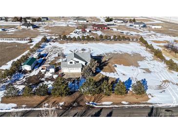 Aerial view of a house with detached garage and spacious yard at 56805 E 33Rd Pl, Strasburg, CO 80136