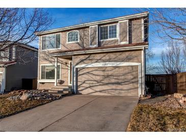 Two-story house with attached garage and landscaped front yard at 1225 Briarhollow Way, Highlands Ranch, CO 80129