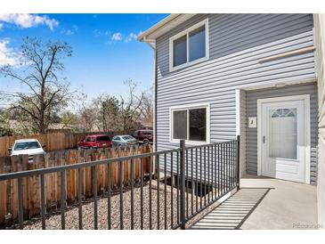 Inviting gray siding with a charming front porch and secure railing entrance to the home at 7845 Barbara Ann Dr # J, Arvada, CO 80004