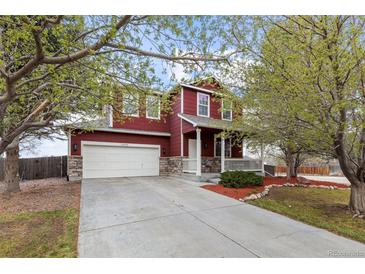Charming two-story home with a well-manicured lawn and inviting front porch at 6202 Ralston St, Frederick, CO 80530