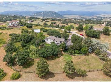 Sprawling property surrounded by lush greenery and trees featuring mountain views, and beautiful landscaping at 6334 Cherokee Dr, Sedalia, CO 80135
