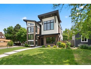 Contemporary home with unique architectural design, brick accents, and manicured lawn at 1500 S Elizabeth St, Denver, CO 80210