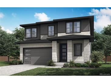 Modern two-story home featuring a two-car garage, stylish stone and siding, and professionally landscaped yard at 8610 Arriba Dr, Littleton, CO 80125