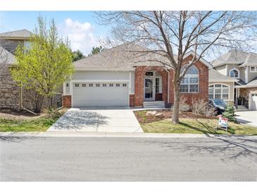 Charming single-Gathering home with a well-manicured front yard and an attached two-car garage at 7141 S Versailles St, Aurora, CO 80016