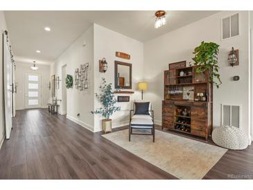 Stylish entryway with wood floors, decor accents, and an inviting bar area at 328 Simmental Loop, Castle Rock, CO 80104