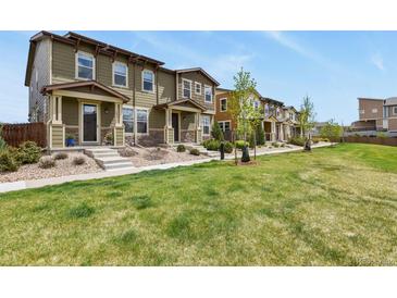 Attractive townhouse exteriors with well-manicured lawns and landscaping in a row of homes at 1273 S Dallas Ct, Denver, CO 80247