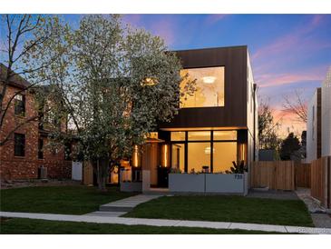 Modern two-story home with a manicured lawn, beautiful flowering tree, and inviting entrance at 735 S Elizabeth St, Denver, CO 80209