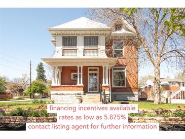 Charming two-story brick home featuring a classic front porch and well-maintained landscaping at 3905 Tejon St, Denver, CO 80211