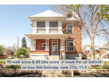 Charming two-story red brick home with a covered front porch and well-maintained landscaping at 3905 Tejon St, Denver, CO 80211