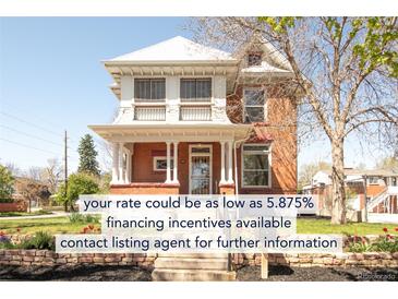 Inviting two-story brick home featuring a classic facade, landscaped front yard, and a welcoming porch with stately columns at 3905 Tejon St, Denver, CO 80211